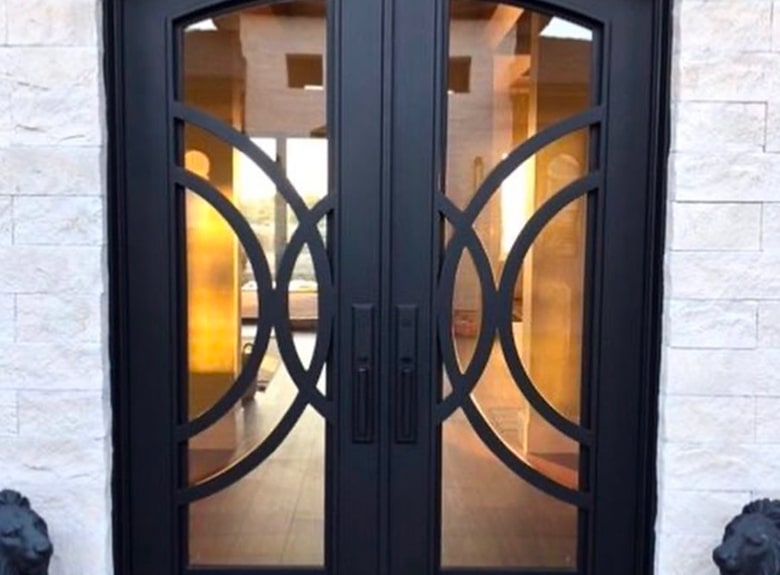 Black double doors with glass panels and decorative metalwork.